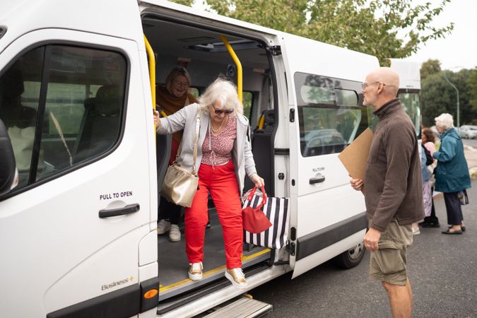 Woman exiting bus at park