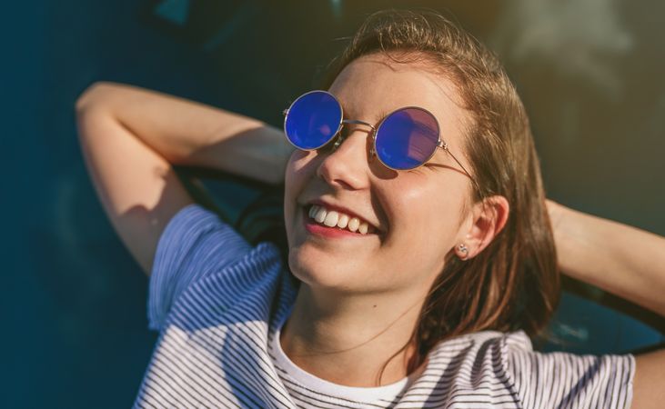 Young woman lying on the windshield