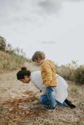 Mother and daughter looking at plants on a fall walk