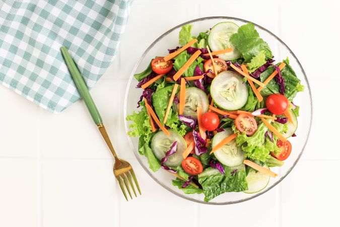 Healthy vegetable Salad with Purple Cabbage, Cherry Tomato, Sliced Cucumber, Carrot, and Lettuce