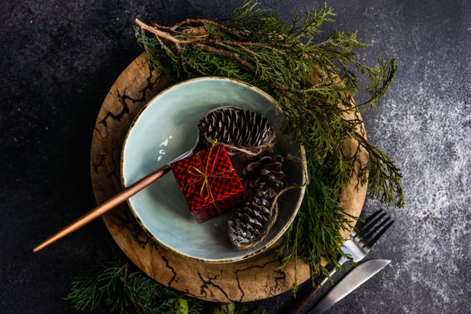 Top view of Christmas table setting with decorative fir and pine cones