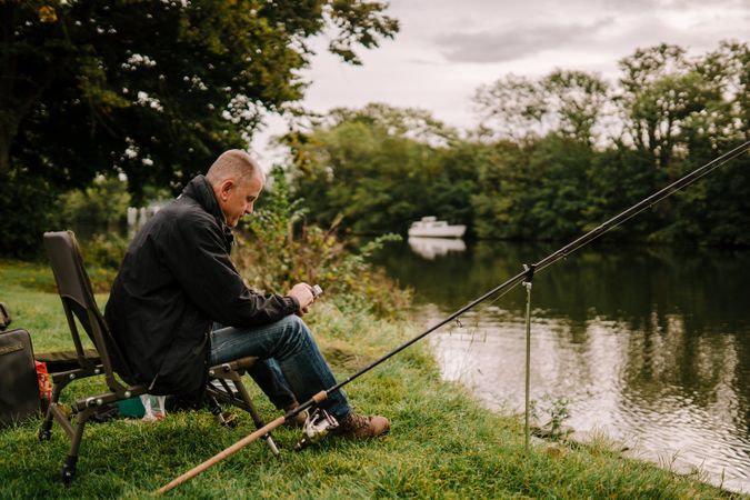 Man fishing in calm river