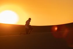 Anonymous photographer standing in desert