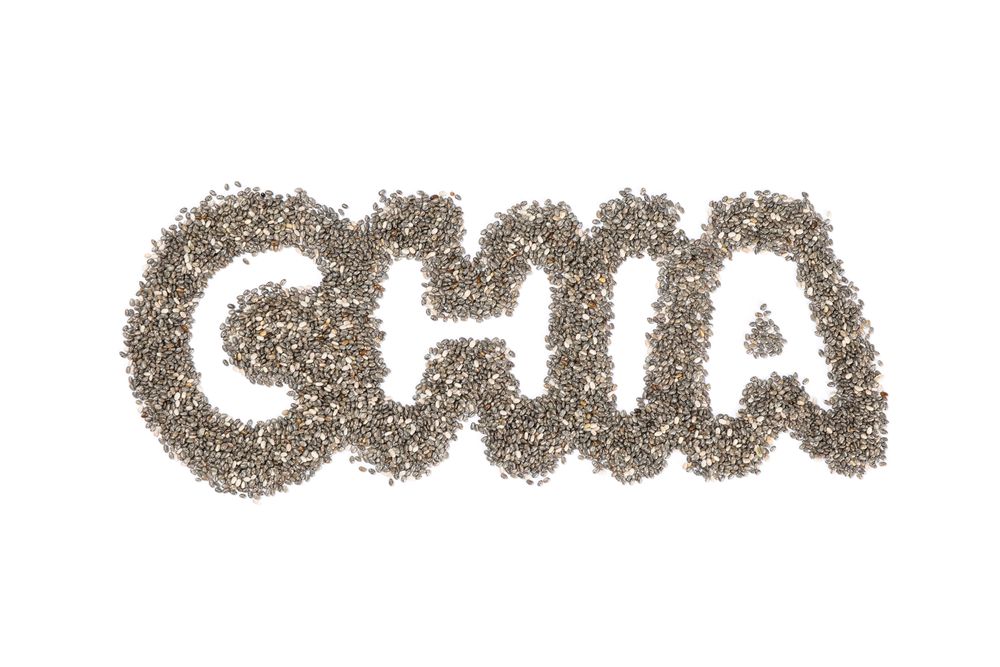 Word Chia layout of chia seeds, isolated on plain background