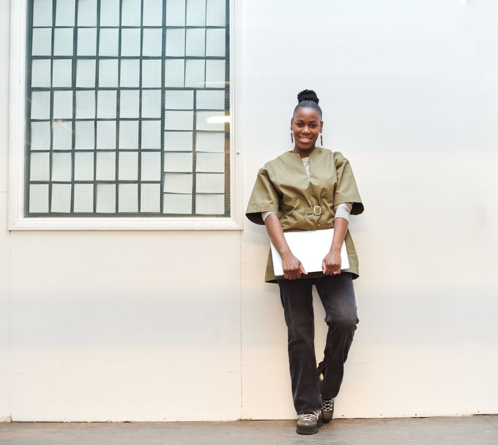 Smiling Black woman with her work computer