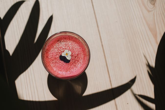 Delicious pink smoothie with frothy in glass