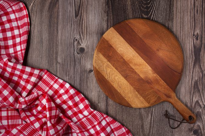 Empty pizza board on rustic wooden table. Top view image.