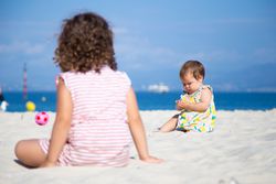 Kids playing on beach in summer
