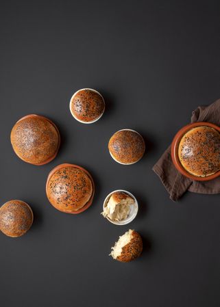 Partially torn bread bowls on dark background