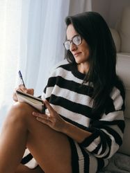 Focused woman taking notes in planner