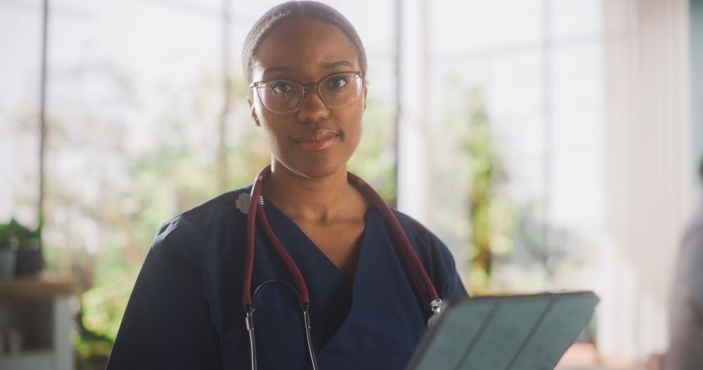 Portrait of a Black Female Doctor Looking at Camera and Smiling.
