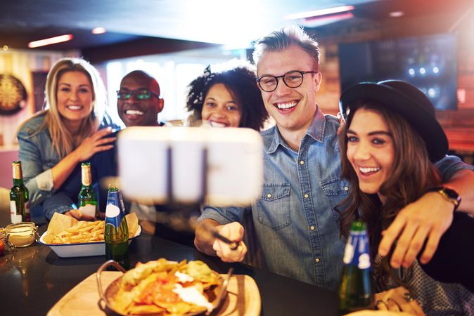 Group of friends taking a picture of themselves at a pub