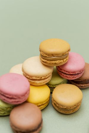 Colored tasty colorful macaroons over a green background