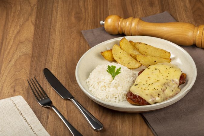 Parmigiana steak with rice and roasted potatoes. Typical Brazilian dish.