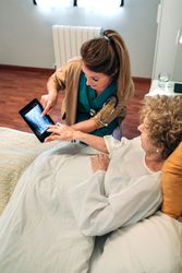 Female doctor showing an x-ray on the tablet