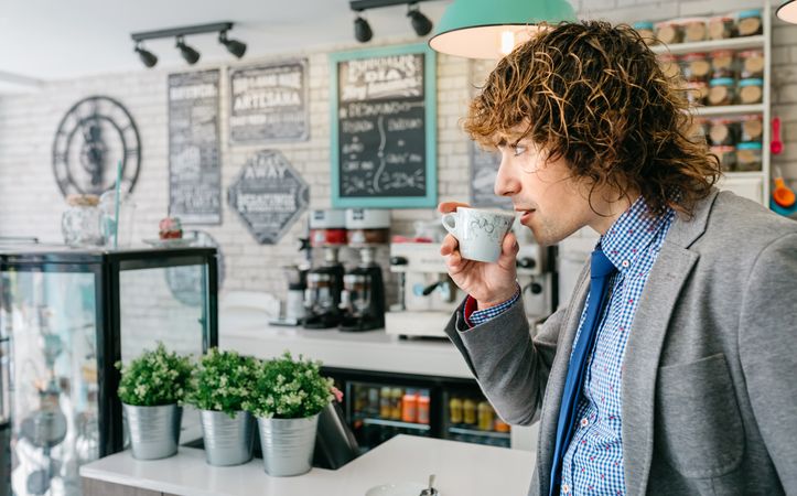 Man drinking coffee in a bar