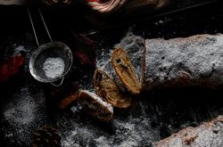Pieces of Stollen near sieve and autumn leaves