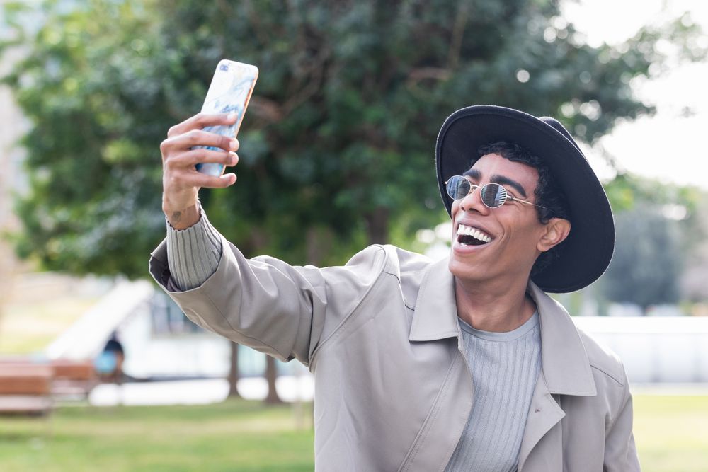 Stylish man taking selfie on smartphone
