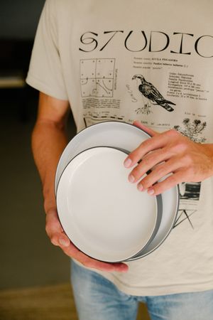 Person holding ceramic bowl