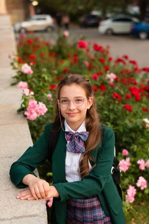 Girl in school uniform smiling confidently