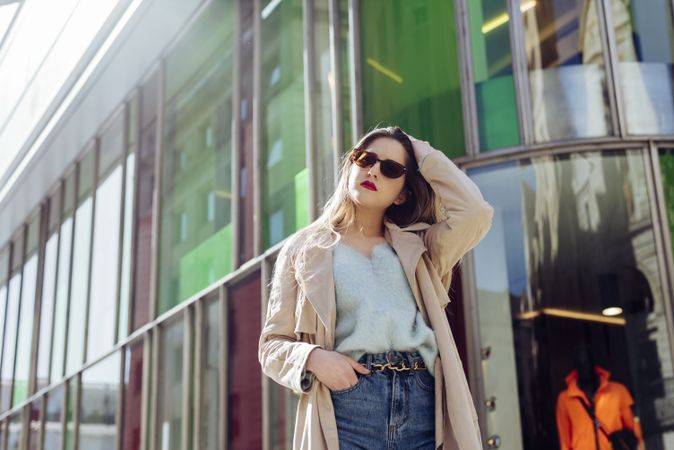 Young woman in sunglasses posing on street