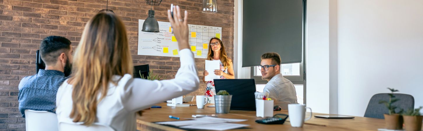 Female manager answering questions in a work meeting