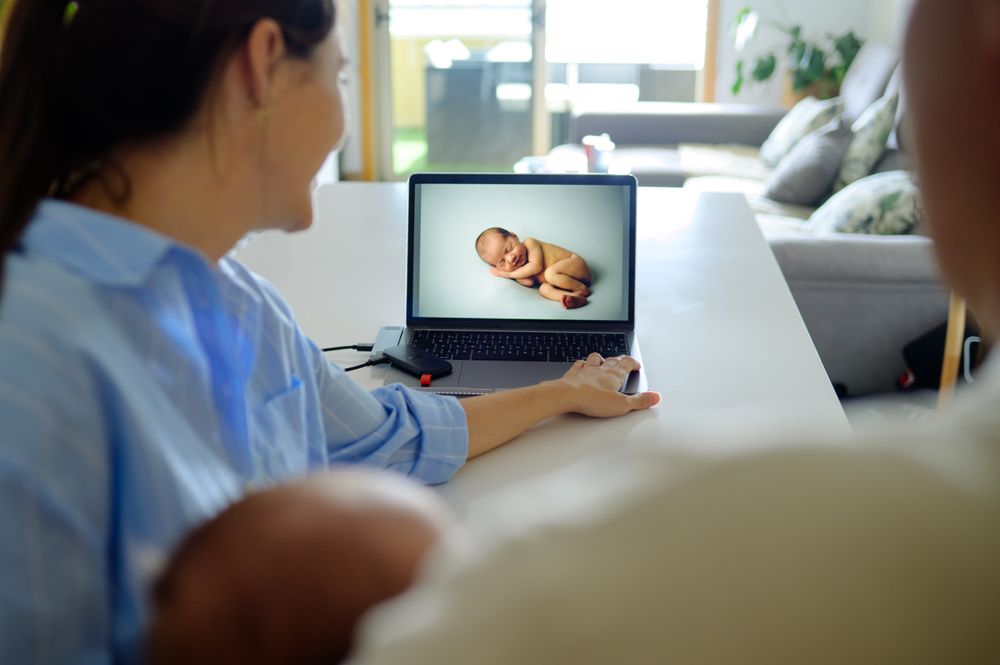 Parents sitting in front of a laptop computer