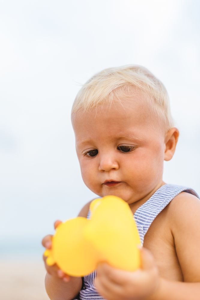 Baby boy playing with rubber ducks