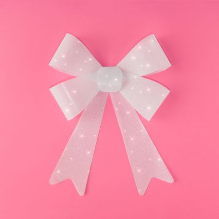 Single gift bow on pink background