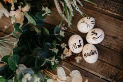 Easter eggs hand painted by children with messages in a wooden table
