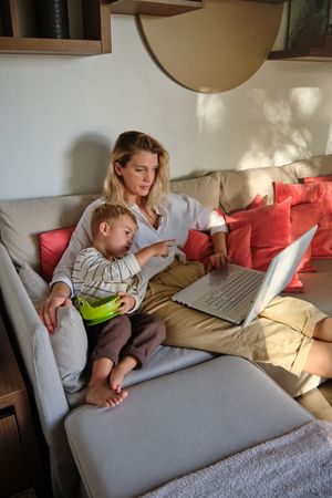 Mother and son watching film on laptop together