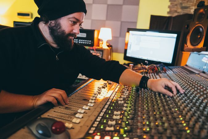 Man in a equalizer instrument in a studio