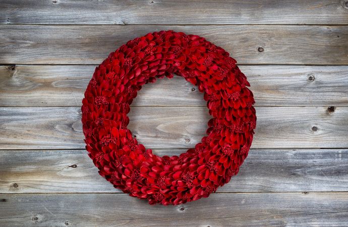Holiday wooden red wreath on rustic wood