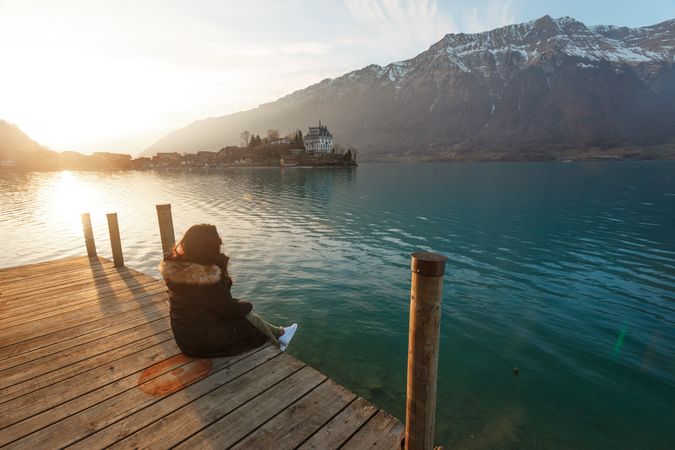 woman on pier in mountains
