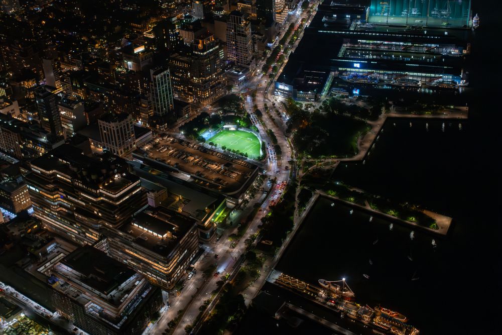 Aerial View of New York City. Helicopter Image of a Highway and Port Area in New York City. Panoramic View with Traffic Around a Big City with Skyscrapers in the Background