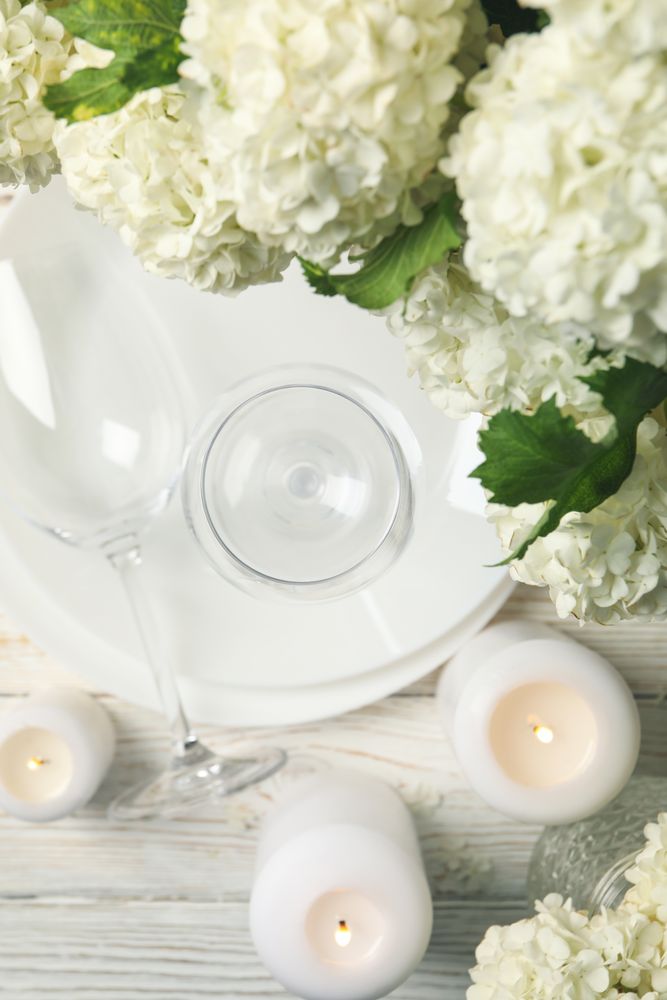 Composition with hydrangea flowers on wooden background, top view. Romantic evening