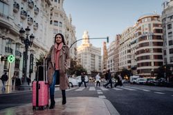 Asian tourist on sidewalk in city