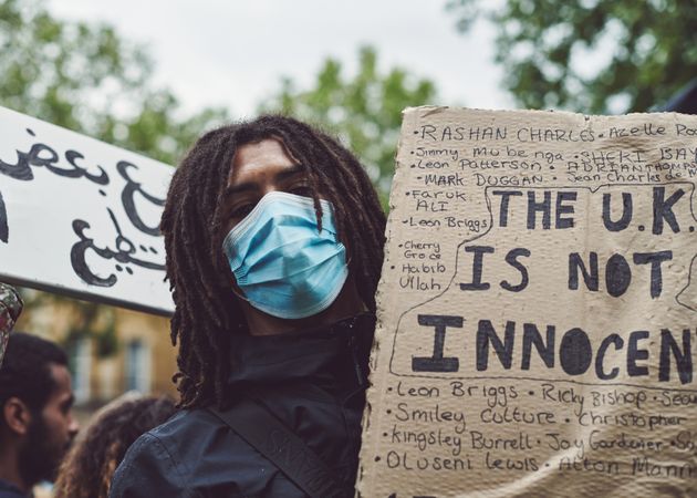 London, England, United Kingdom - June 6th, 2020: Man with dreadlocks holding sign at BLM protest