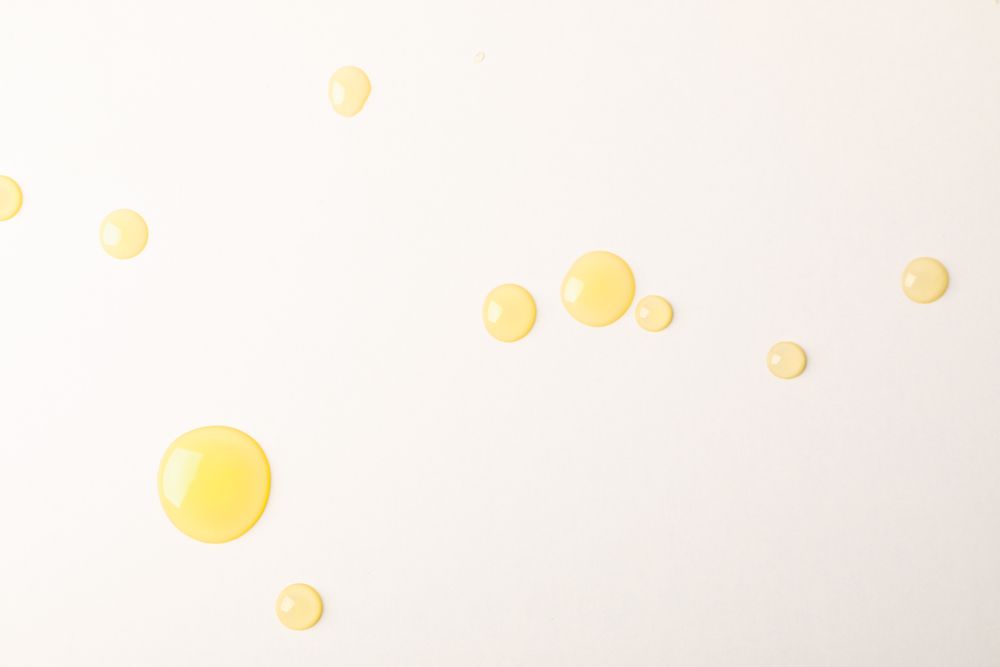Honey drops on blank background, space for text