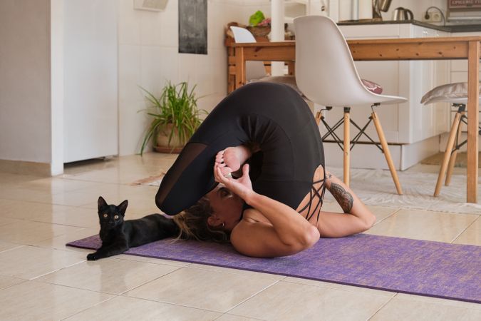 Slim woman doing yoga at home