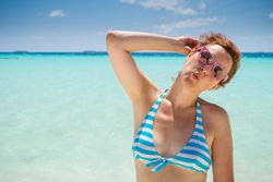 Woman grimacing near sea