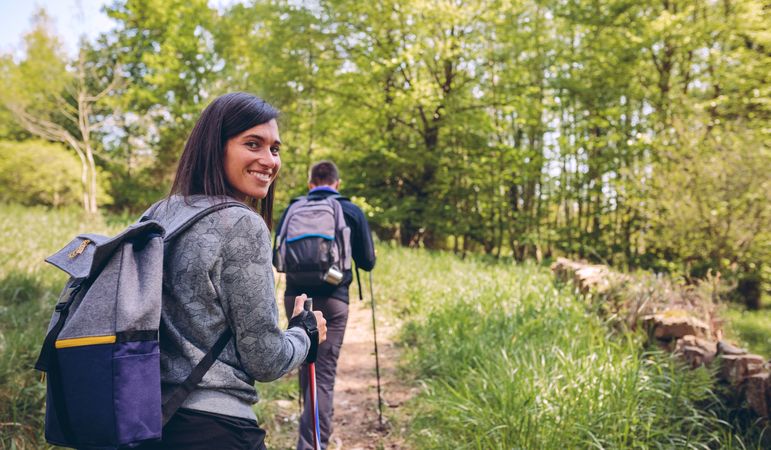 Woman doing trekking looking at camera