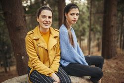 Smiling women in sweaters in park