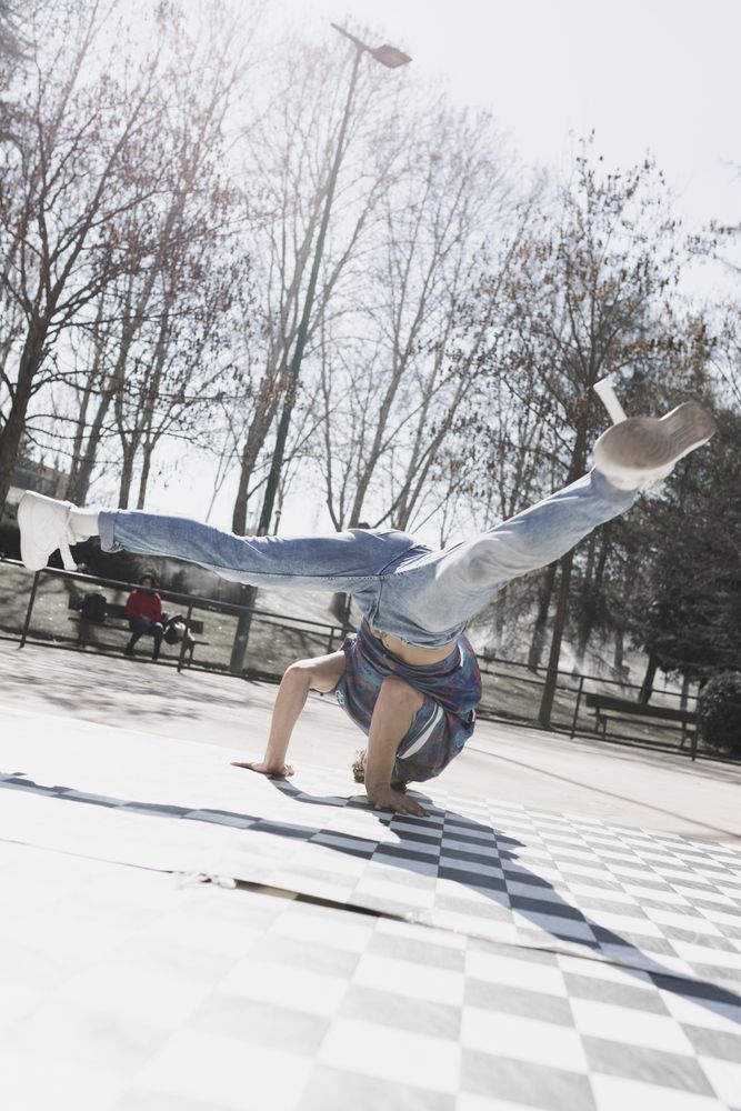 Man dancing break dance in park