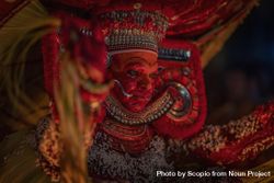 Indian man disguised as Theyyam as part of ritual form of dance worship 5XA6V4