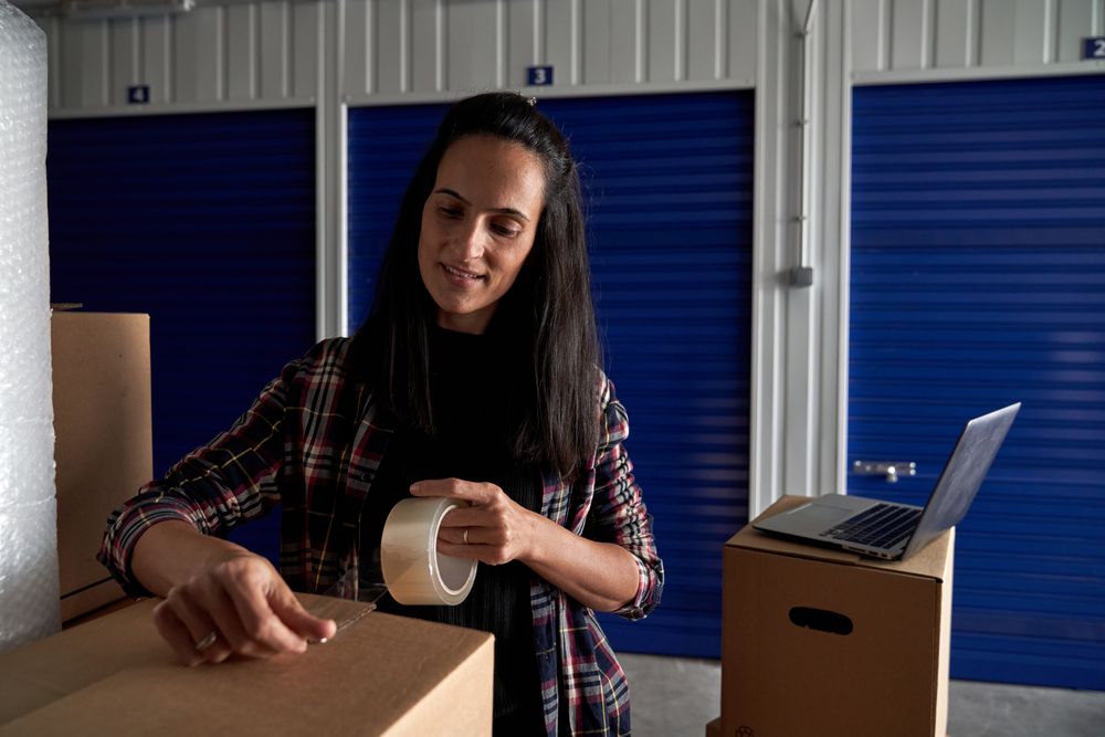 Content woman packing cardboard box