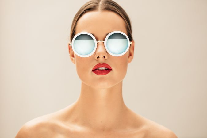 Female fashion model posing with sunglasses
