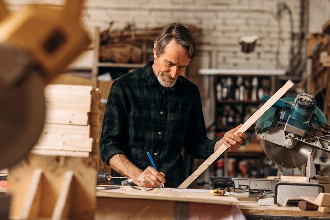 Older male woodworker in his studio