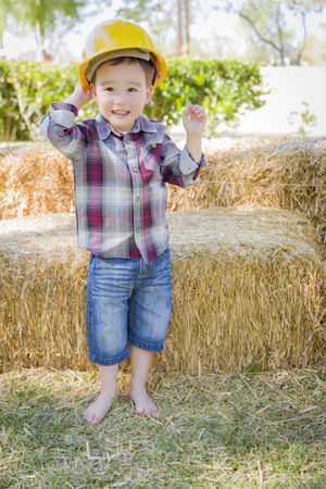 Toddler Boy Laughing with Hard Hat Outside