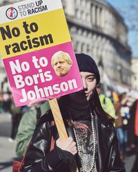 London, England, United Kingdom - March 19 2022: Woman with “no to racism” sign